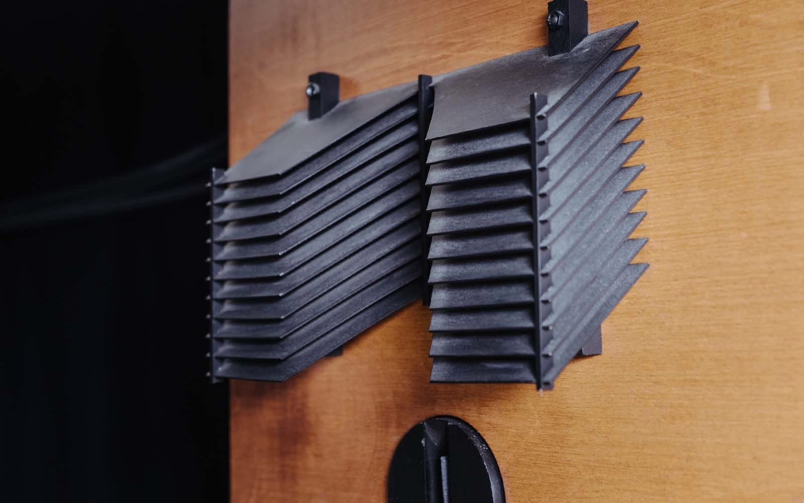 Black horn-loaded tweeters mounted on a wooden panel at Cosmic Slop