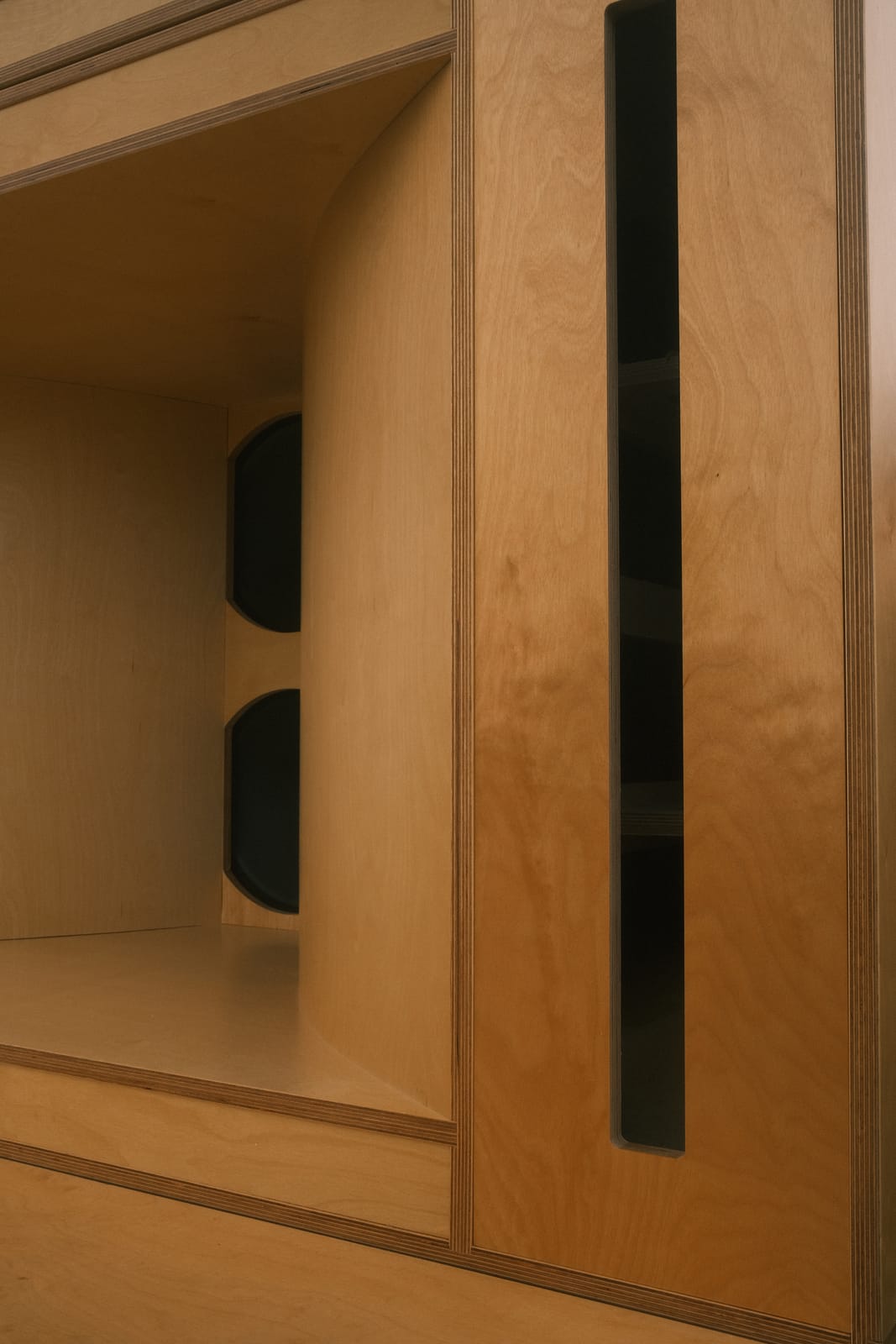 Loudspeaker drivers built into birch plywood joinery in a converted chapel