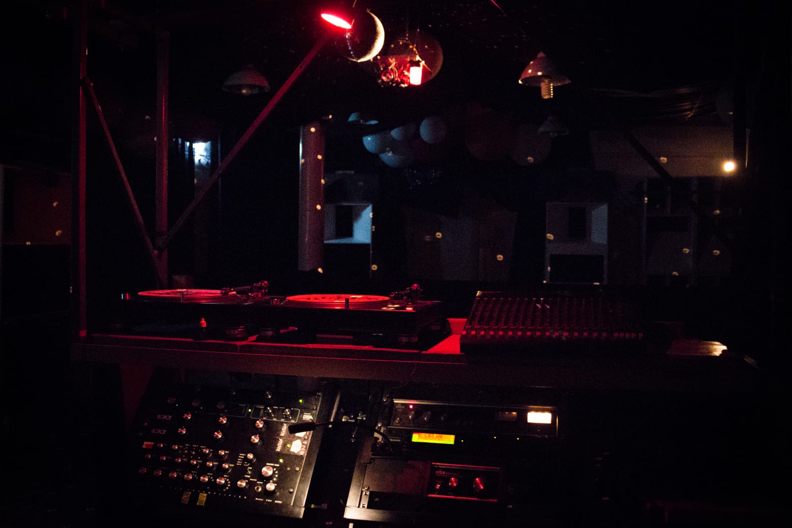 A crowd dancing in front of the Sunflower Sound System at night