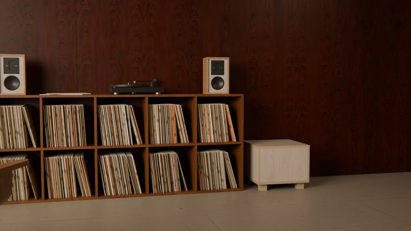 An SA Sub beside a record shelf with a pair of SA5 loudspeakers
